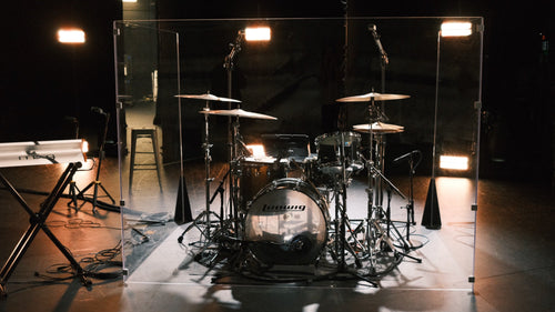Pure Shields drum shield on a church stage