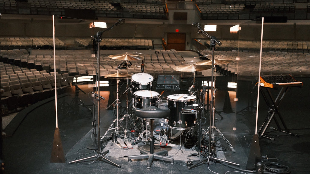 Pure Shields drum shield on a church stage