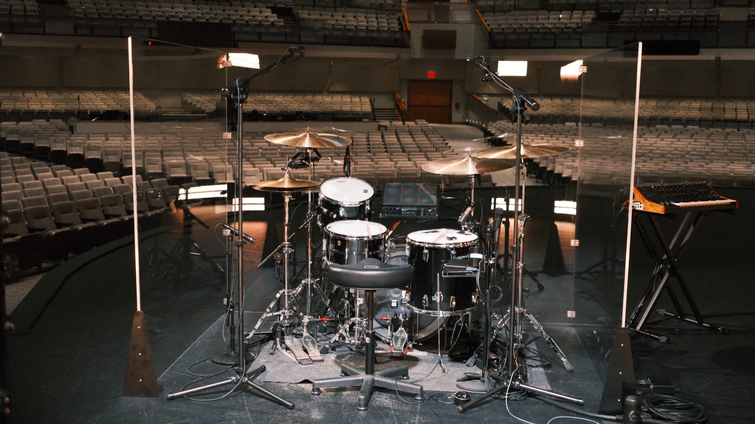 Pure Shields drum shield on a church stage